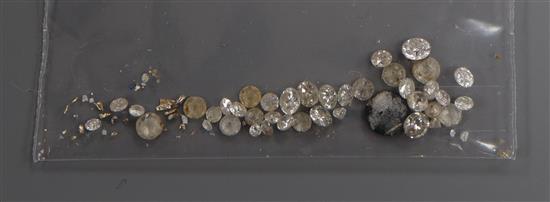 A small quantity of loose gemstones including diamonds.